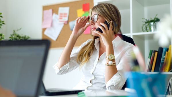 busy woman on the phone at desk
